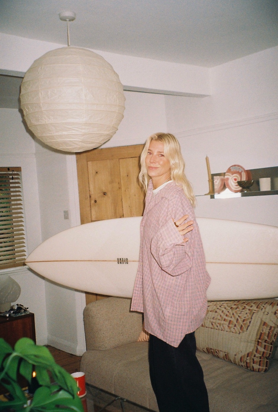 Lindsey Holland, founder of Marnie Rays, with her surfboard